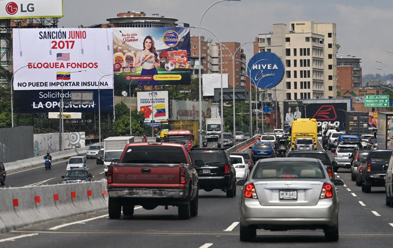 A billboard in Caracas blames the opposition for the harm caused by U.S. sanctions against Venezuela as the autocratic Nicolás Maduro prepares to secure a third term as president in July elections.