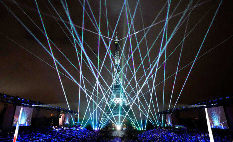 Jul 26, 2024; Paris, FRANCE; A laser show in front of the Eiffel Tower as seen from the Trocadero during the Opening Ceremony for the Paris 2024 Olympic Summer Games along the Seine River. Mandatory Credit: Rob Schumacher-USA TODAY Sports