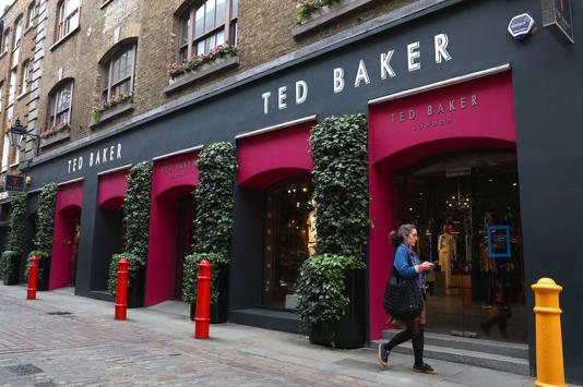 A woman walks past a Ted Baker store in Covent Garden in London