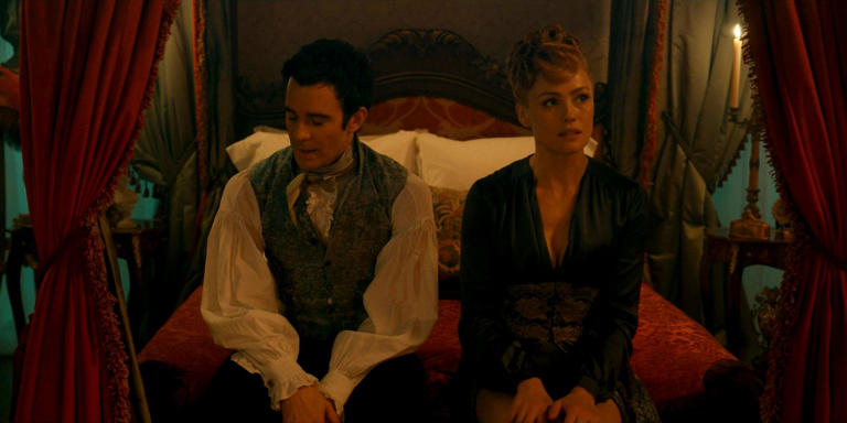 Benedict Bridgerton (Luke Thompson) and Lady Tilley Arnold (Hannah New) sitting on the edge of the bed, discussing if they should start a formal relationship in Bridgerton season 3 episode 8