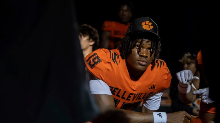 Belleville quarterback Bryce Underwood (19) looks up at one of his coaches as he kneels alongside his teammates after a 35-8 victory against Westland Glenn in Belleville on Friday, Sept. 29, 2023. | David Rodriguez Munoz/Detroit Free Press