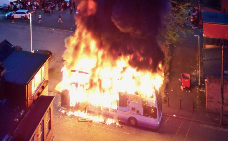 Police car flipped over and bus on fire in Leeds as riots break out