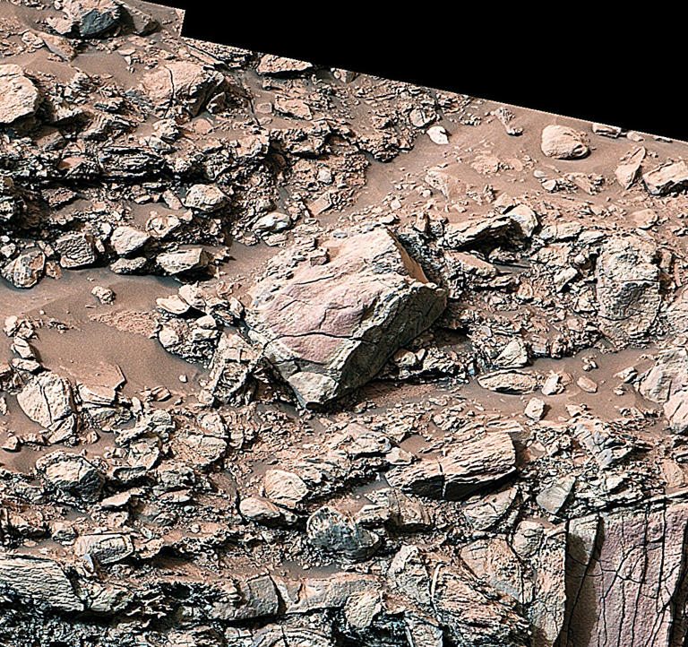 While exploring Gediz Vallis channel in May, NASA’s Curiosity captured this image of rocks that show a pale color near their edges. These rings, also called halos, resemble markings seen on Earth when groundwater leaks into rocks along fractures, causing chemical reactions that change the color. Credit: NASA/JPL-Caltech/MSSS