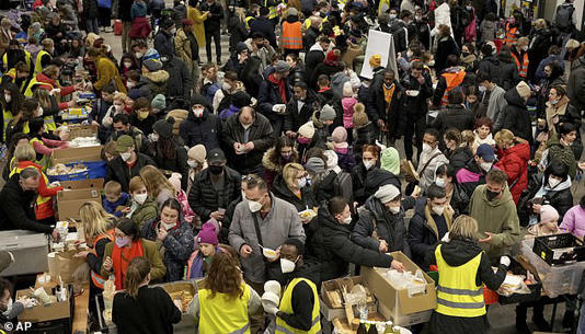 Ukrainian refugees queue for food in the welcome area after their arrival at the main train station in Berlin, Germany, March 8, 2022