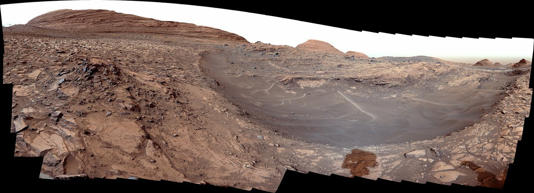 Mars' Gediz Vallis channel with large buildups of rocky debris.
