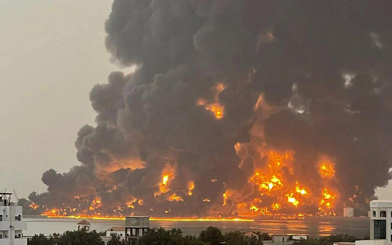 A handout picture obtained from Yemen's Huthi Ansarullah Media Center show a huge column of fire erupting following airstrikes in the Yemeni rebel-held port city of Hodeida on July 20, 2024. (Photo by AFP)