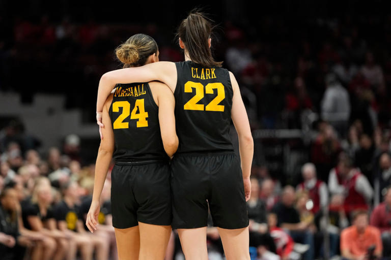 Iowa Hawkeyes guard Caitlin Clark (22) puts her arm around guard Gabbie Marshall (24) din the final seconds of the second half of the NCAA women's basketball game against the Ohio State Buckeyes at Value City Arena. Ohio State lost 83-72. Adam Cairns/Columbus Dispatch / USA TODAY NETWORK