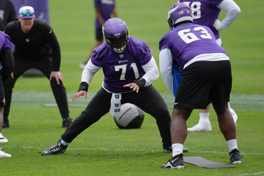 Minnesota Vikings offensive tackle Christian Darrisaw (71) takes part in drills during an NFL football minicamp workout in Eagan, Minn., Thursday, June 6, 2024. AP