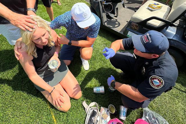 Courtesy Katie Hauss An EMT attends to Katie Hauss, the woman who was hit the head by Travis Kelce's golf ball