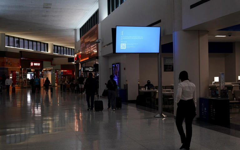 A screen showing the "Blue Screen of Death" inside Newark International Airport in New Jersey, July 19 - Bing Guan/Reuters