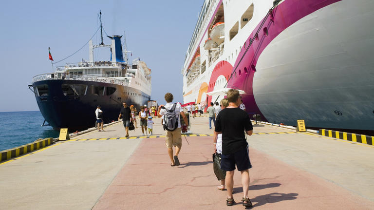 people walking on ship dock