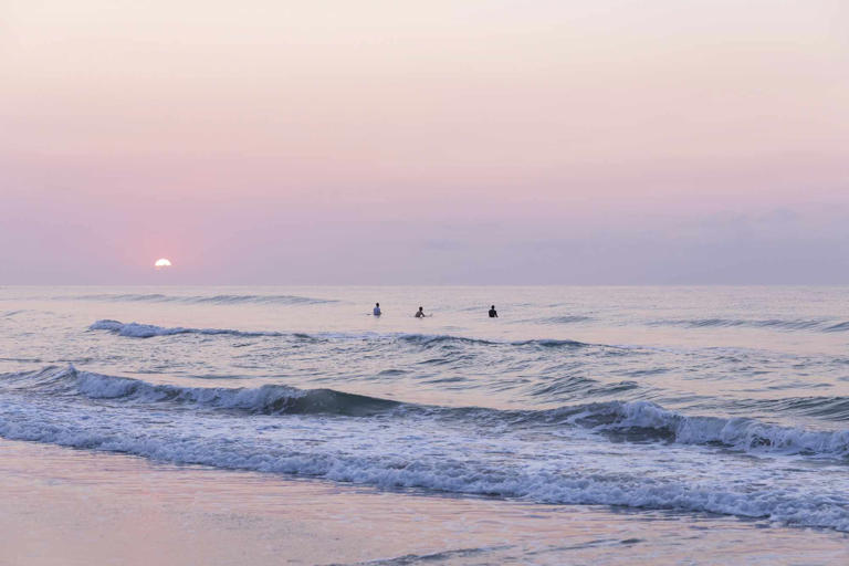 Leslie Ryann McKellar Surfers at sunrise on Wrightsville Beach, just east of Wilmington, North Carolina.