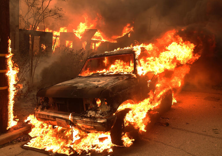 A car burns as the Eaton Fire moves through the area on January 08, 2025 in Altadena, (Getty Images)