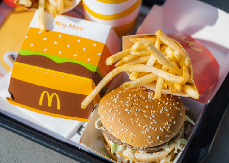 A tray with a McDonald's Big Mac burger, fries, and a Big Mac box.