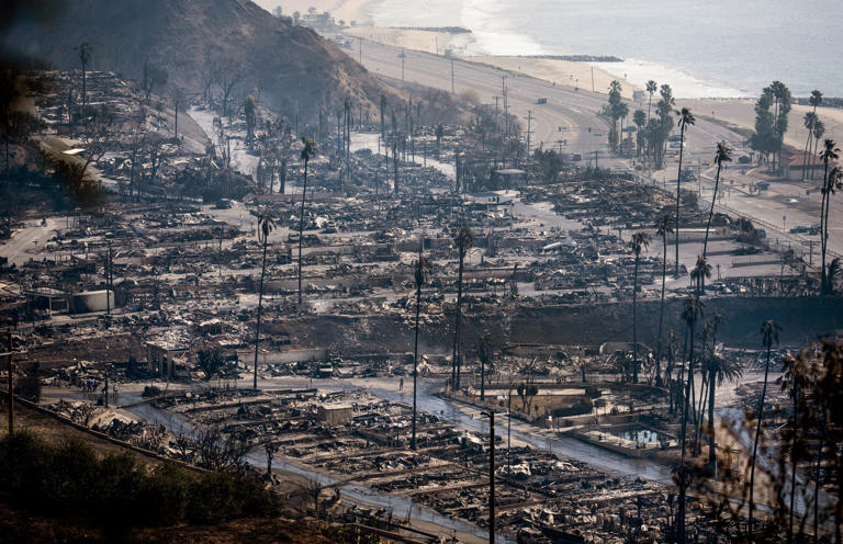 Businesses and homes burned along the Pacific Coast Highway in the Pacific Palisades neighborhood of Los Angeles on Thursday.