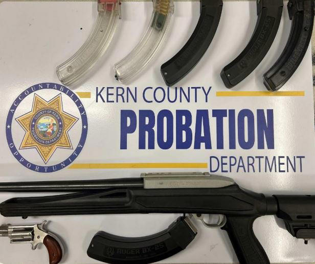 Man arrested after probation officers locate 2 loaded weapons and ...