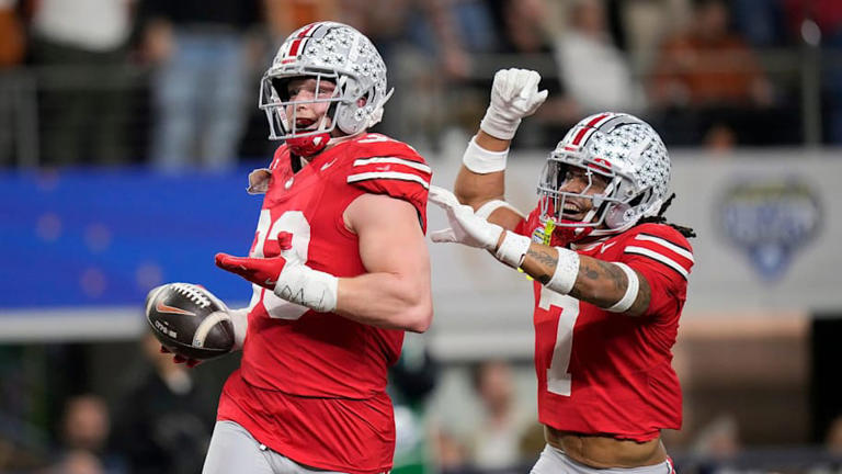 Ohio State Buckeyes defensive end Jack Sawyer (33) celebrates his touchdown return with Ohio State Buckeyes cornerback Jordan Hancock (7) against Texas Longhorns in the fourth quarter of the Cotton Bowl Classic during the College Football Playoff semifinal game at AT&T Stadium in Arlington, Texas on January, 10, 2025. | Kyle Robertson/Columbus Dispatch / USA TODAY NETWORK via Imagn Images