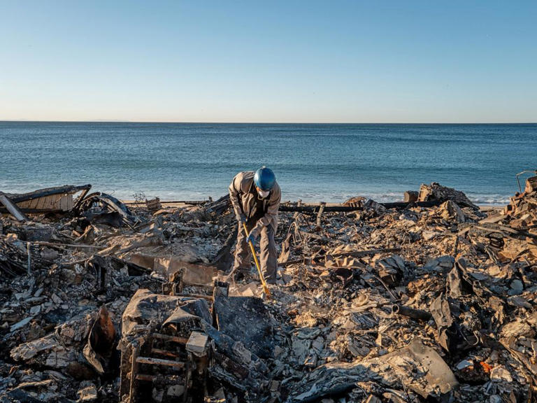 Patrick O'Neal sifts through his home after it was destroyed by the Palisades wildfire, Jan. 13, 2025, in Malibu, Calif.