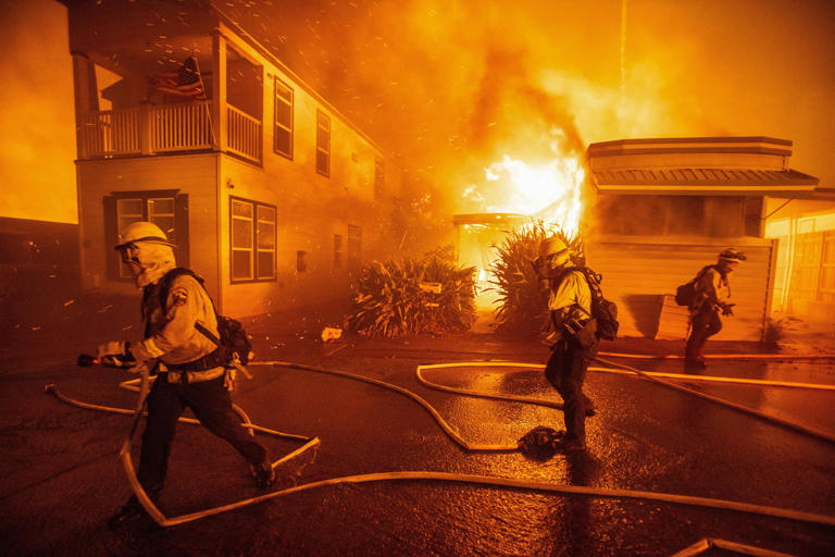 Firefighters battle the Palisades Fire as it burns during a windstorm on the west side of Los Angeles on U.S. Jan. 7, 2025.