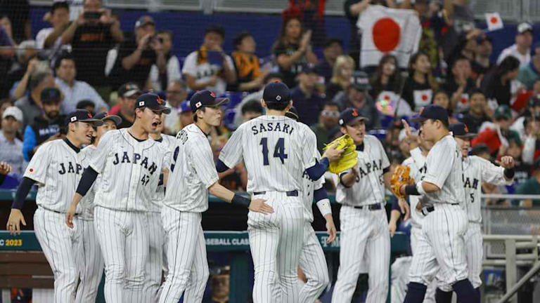 Japan starting pitcher Roki Sasaki (14) celebrates with teammates after the first inning against Mexico at LoanDepot Park in 2023. | Sam Navarro-Imagn Images