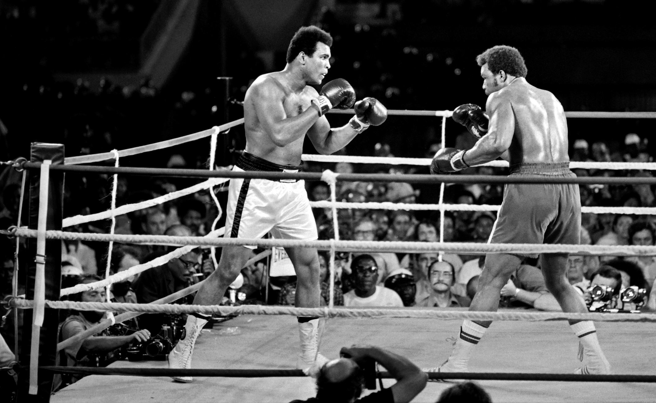Ali and titleholder George Foreman fight on October 30, 1974 in Kinshasa, Zaire during their world heavyweight championship match. Ali won by knocking out Foreman in the eighth round.