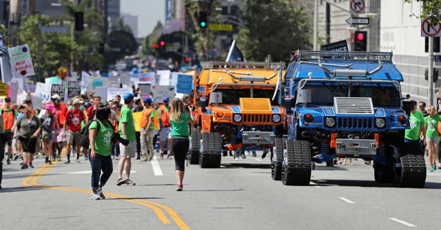 Slide 2 of 24: Two giant electric Humvees lead thousands of people in a march and rally in downtown Los Angeles, part of the nationwide March for Science, taking place Saturday, April 22, 2017. They chanted "Money for science and education, not for wars and climate alteration."