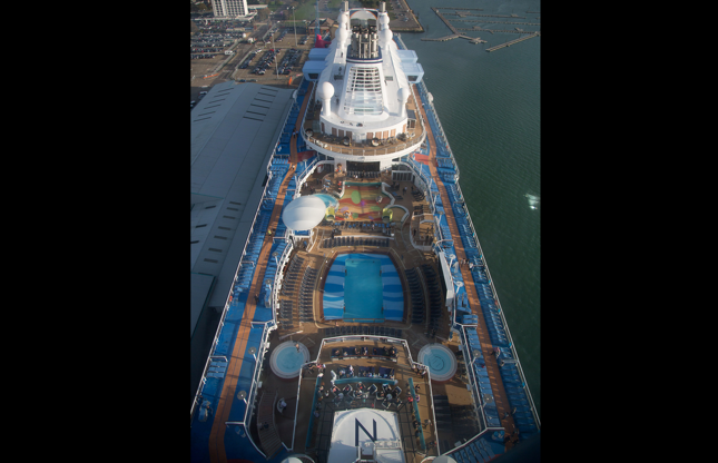 ÎÎ¹Î±ÏÎ¬Î½ÎµÎ¹Î± 4 Î±ÏÏ 24: SOUTHAMPTON, ENGLAND - OCTOBER 31: People sit and enjoy the facilites on the top deck onboard the cruise ship Quantum of the Seas which is currently docked at Southampton on October 31, 2014 in Southampton, England. Billed as the world's first smartship, Royal Caribbean's Quantum of the Seas is claimed to be the most high-tech cruise ship in the world, with high tech modifications such as virtual balconies in windowless rooms and features such as the first dodgem ride on water, and a skydiving simulator. The ship will shortly begin its voyage from Southampton, where it docked earlier this week, to New York before relocating to the Caribbean for the 2014-15 season. (Photo by Matt Cardy/Getty Images)