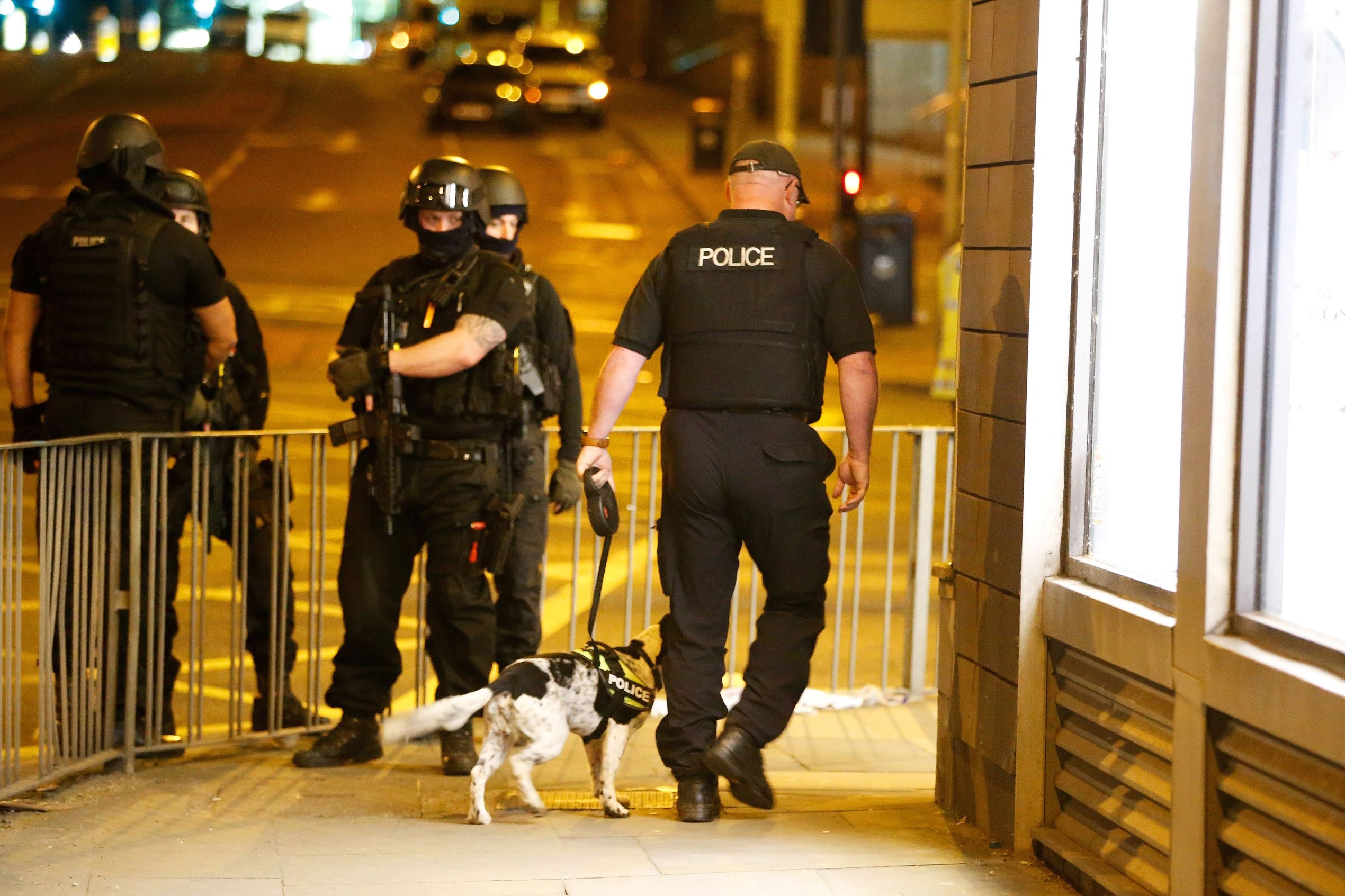 Slide 16 of 27: Armed police officers stand near the Manchester Arena, where U.S. singer Ariana Grande had been performing, in Manchester, in northern England, Britain May 23, 2017.