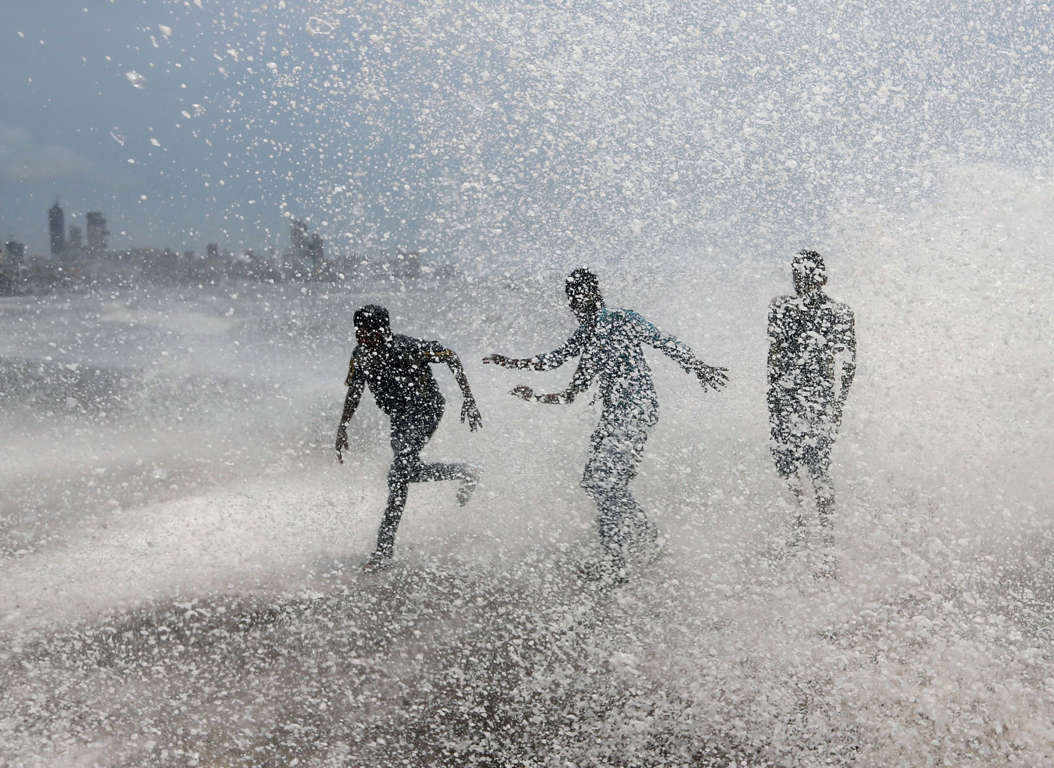 Slide 8 of 33: People get drenched by a large wave during high tide at a seafront in Mumbai, India, June 12, 2017. REUTERS/Danish Siddiqui TPX IMAGES OF THE
