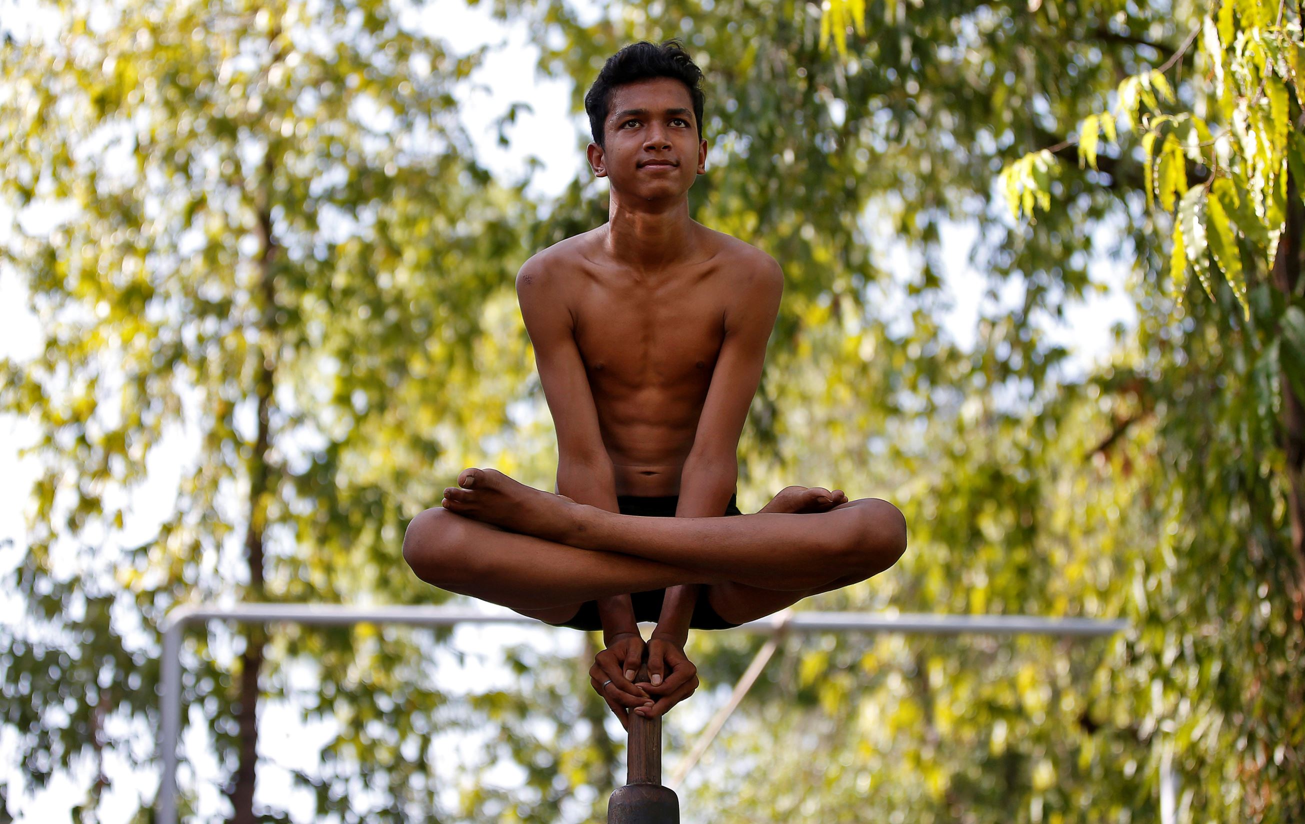 Slide 22 of 33: A performer practices "Malkhamb" (traditional Indian gymnastics) during a rehearsal for the upcoming annual Rath Yatra, or chariot procession, in Ahmedabad, India, June 10, 2017. REUTERS/Amit Dave TPX IMAGES OF THE