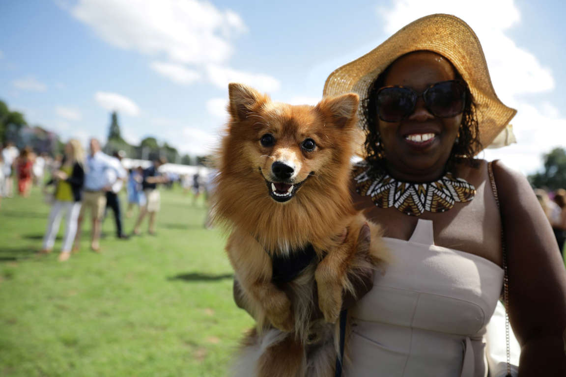 Slide 23 of 33: A woman poses with her dog at a Polo event in Hurlingham Park in London, Britain June 10, 2017. REUTERS/Kevin Coombs TPX IMAGES OF THE