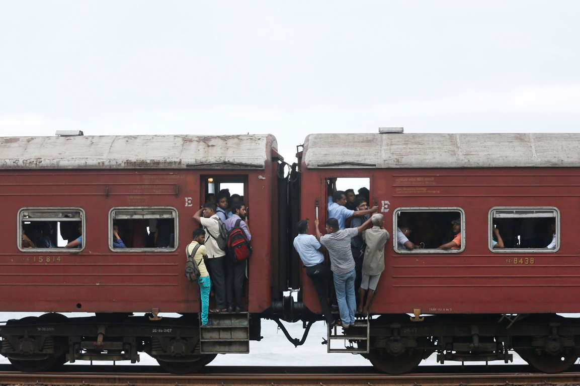 Slide 26 of 33: People travel in a train to work in Colombo,Sri Lanka June 14, 2017. REUTERS/Dinuka Liyanawatte TPX IMAGES OF THE