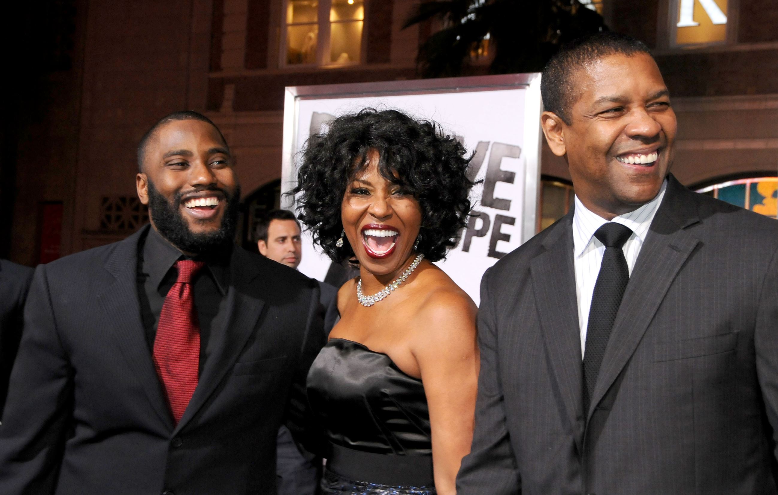 Slide 12 of 28: HOLLYWOOD, CA - JANUARY 11: John David Washington, Pauletta Washington and Denzel Washington arrive at 'The Book Of Eli' Los Angeles Premiere at Grauman's Chinese Theater on January 11, 2010 in Hollywood, California. (Photo by Gregg DeGuire/FilmMagic)