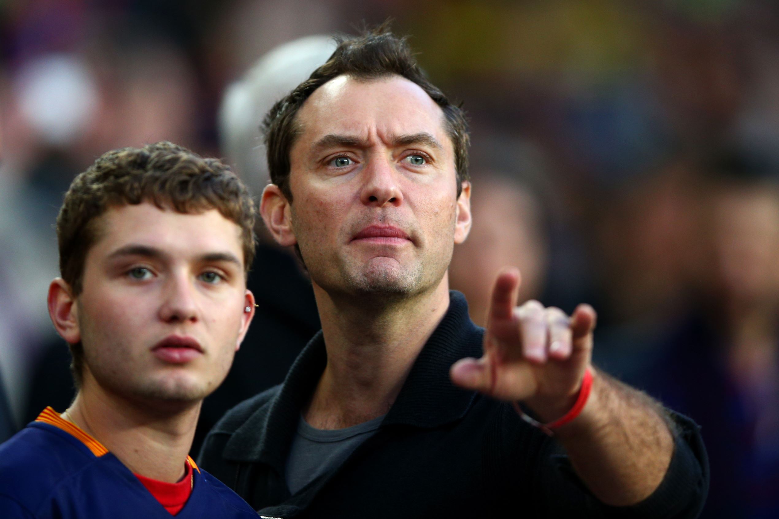 Slide 5 of 28: BARCELONA, SPAIN - APRIL 02:  Actor Jude Law takes his seat next to his son Rafferty Law before the start of the La Liga match between FC Barcelona and Real Madrid CF at Camp Nou on April 2, 2016 in Barcelona, Spain.  (Photo by Paul Gilham/Getty Images)
