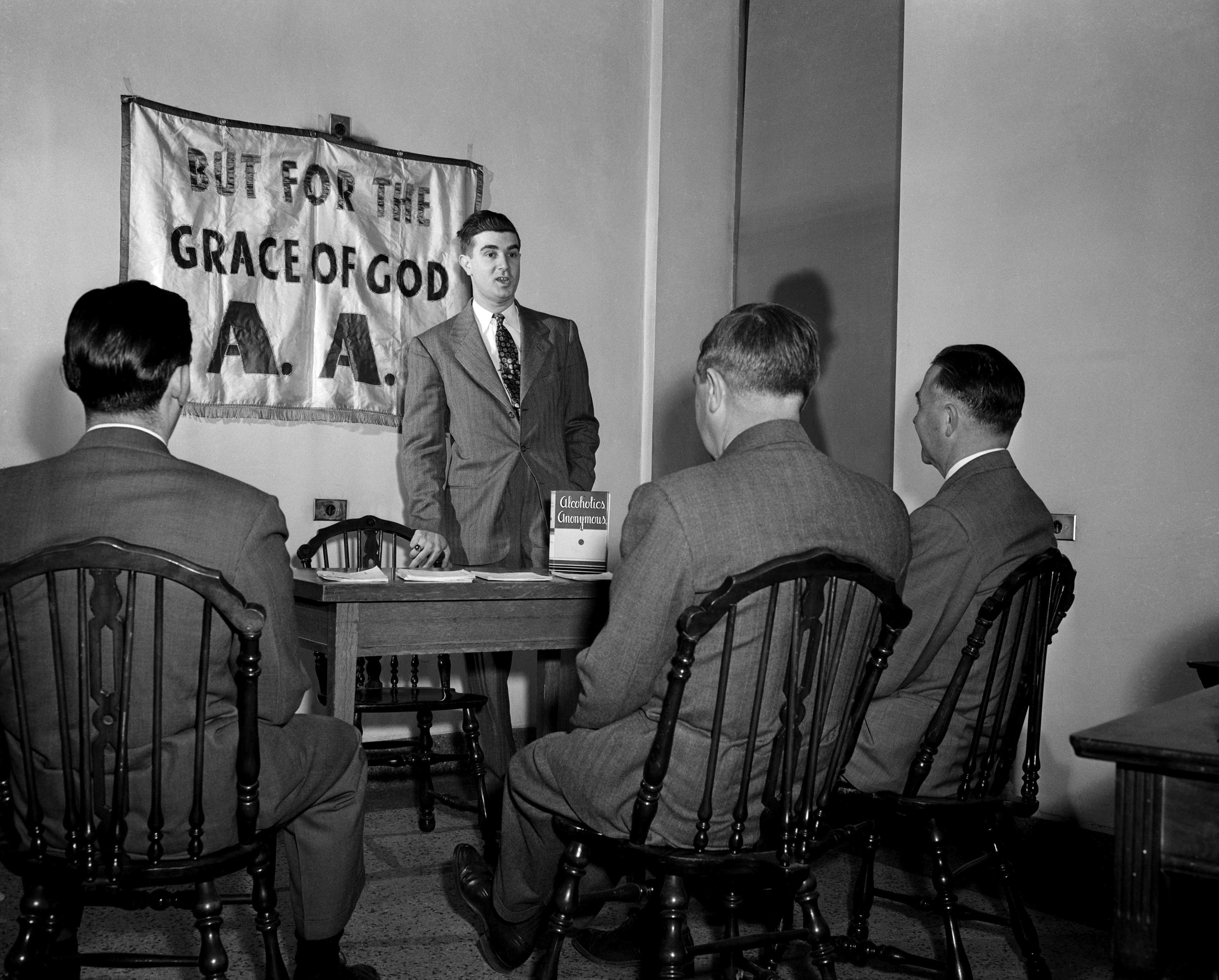 Slide 4 of 13: After three months without a drink, John finds himself an Alcoholics Anonymous crusader, helping the good work of saving others by telling of his successful fight. Photograph circa 1950.