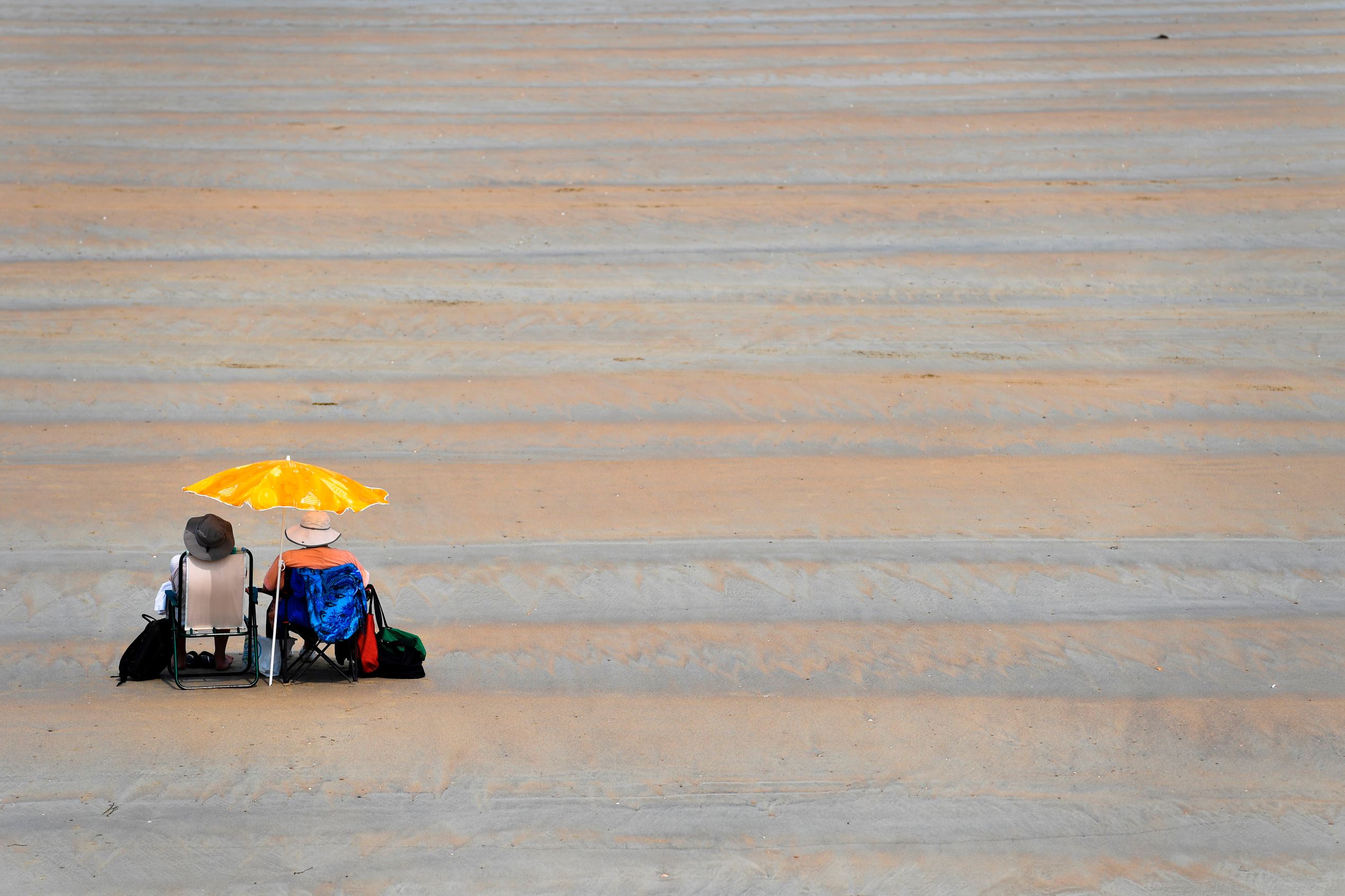 Slide 7 of 40: People enjoy the warm weather on the beach of Saint-Malo, western France, on June 20, 2017 as French national meteorological service, Meteo France is forecasting record temperatures for June 21 in western France.