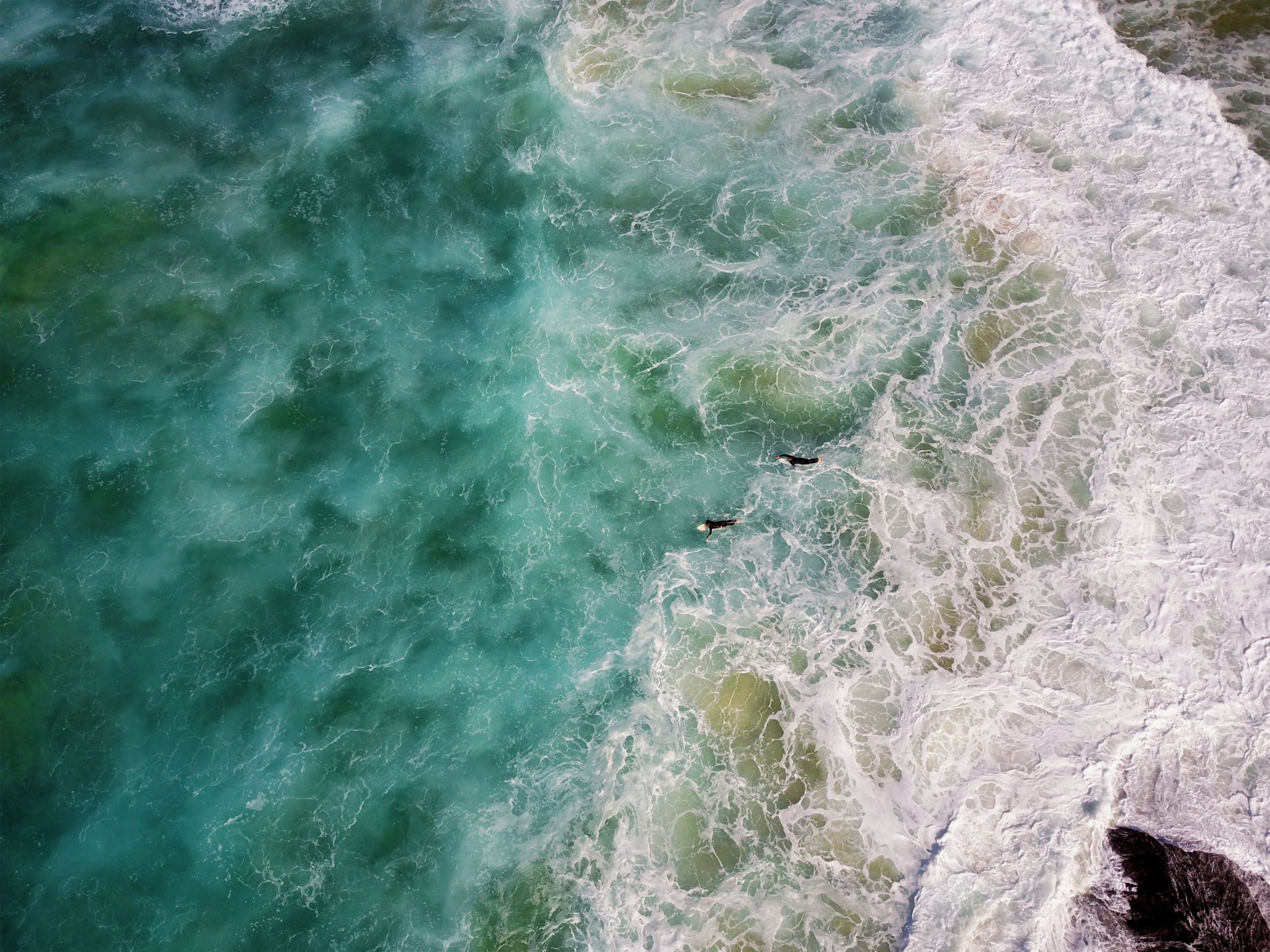 Slide 9 of 40: Surfers make their way out to sea from the rocks at Tamarama as heavy swell impacts the Sydney coast on June 20, 2017 in Sydney, Australia.