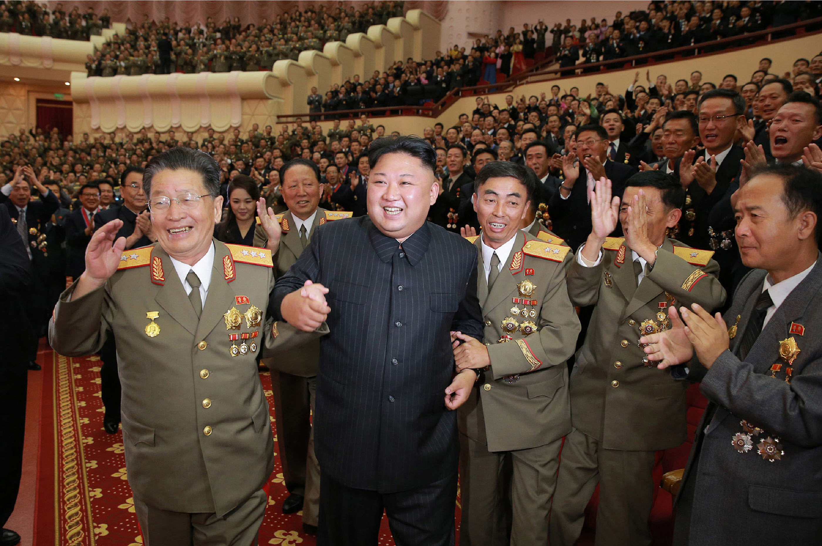 Διαφάνεια 28 από 36: This undated picture released by North Korea's official Korean Central News Agency (KCNA) on September 10, 2017 shows North Korean leader Kim Jong-Un (front 2nd L) attending an art performance dedicated to nuclear scientists and technicians, who worked on a hydrogen bomb which the regime claimed to have successfully tested, at the People's Theatre in Pyongyang.