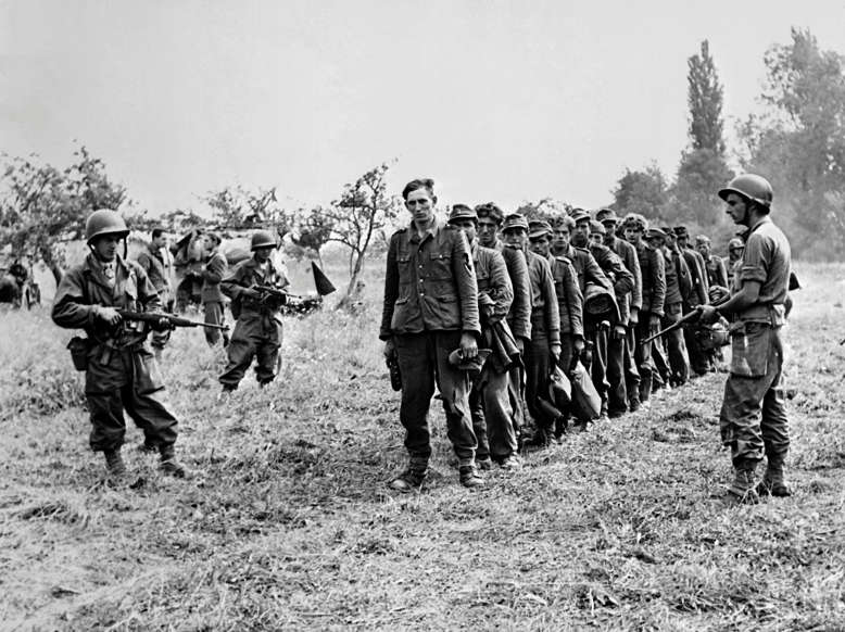 Slide 60 of 100: Photo taken on September 1944 during the World War II of German prisoners under guard of the 2nd Armored Division of the French Leclerc army.