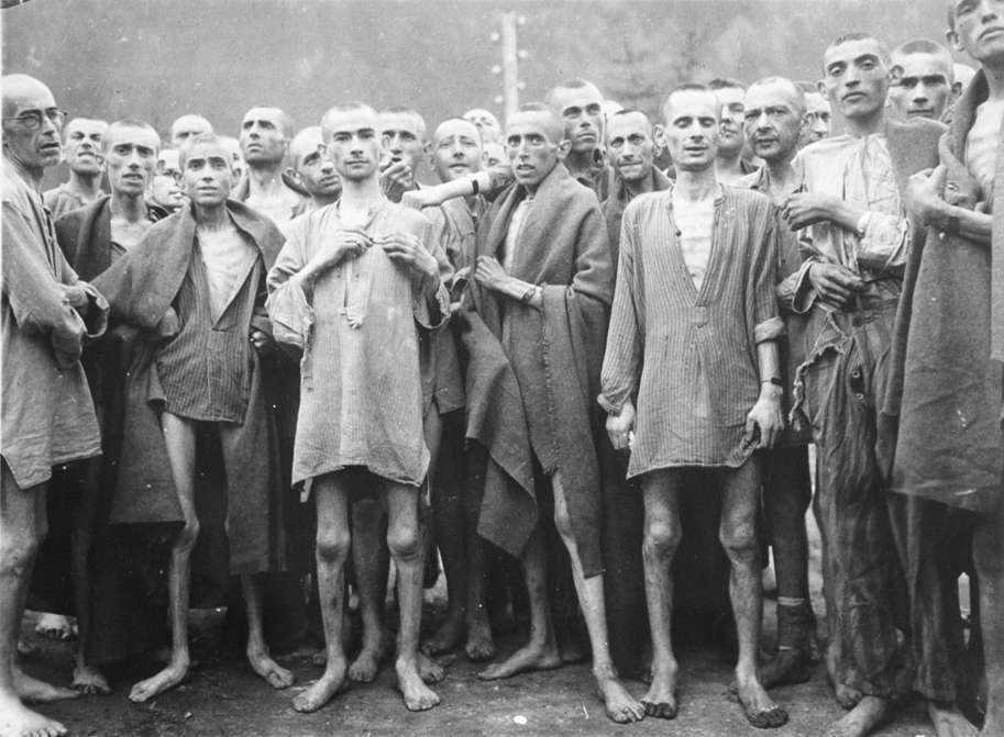Slide 87 de 100: Starved prisoners, nearly dead from hunger, pose in concentration camp May 7, 1945 in Ebensee, Austria. The camp was reputedly used for 'scientific' experiments.