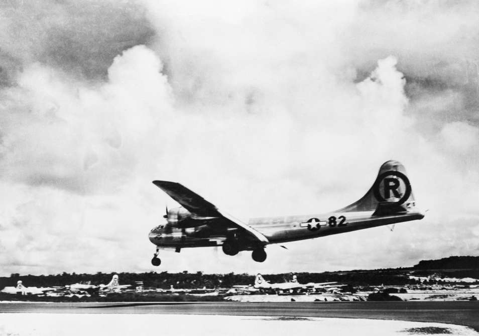 Slide 41 de 100: The Enola Gay lands back on Tinian after dropping the first military atomic bomb on Hiroshima.