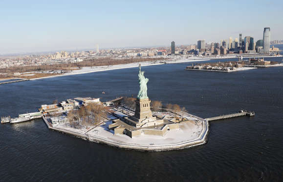 Slide 3 of 85: NEW YORK, NY - JANUARY 05:  A blanket of snow covers Liberty Island on January 5, 2018 in New York City. Under frigid temperatures, New York City dug out from the "Bomb Cyclone."