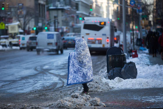 Slide 18 of 85: Monique, aged 27, who has been homeless for a year waits to cross the street during freezing temperatures in Manhattan, New York, as brutal cold weather followed yesterday's winter storm. 05 January 2018.