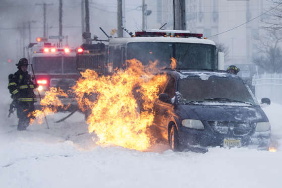 Slide 21 of 85: Firefighters extinguish a vehicle fire during a winter snowstorm in Atlantic City, N.J., Thursday, Jan. 4, 2018. State government offices were closed, and NJ Transit reported lighter-than-normal ridership. Gov. Chris Christie declared a state of emergency for four coastal counties.