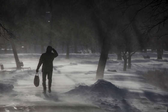 Slide 16 of 85: The wind blows snow onto a man as he walks along a path on the Charles River Esplanade in Boston on Jan. 5, 2018. Temperatures are expected to drop into the single digits and winds gusting up to 50 MPH will drive wind chills to as much as 25 below zero a day after a winter storm in the city.
