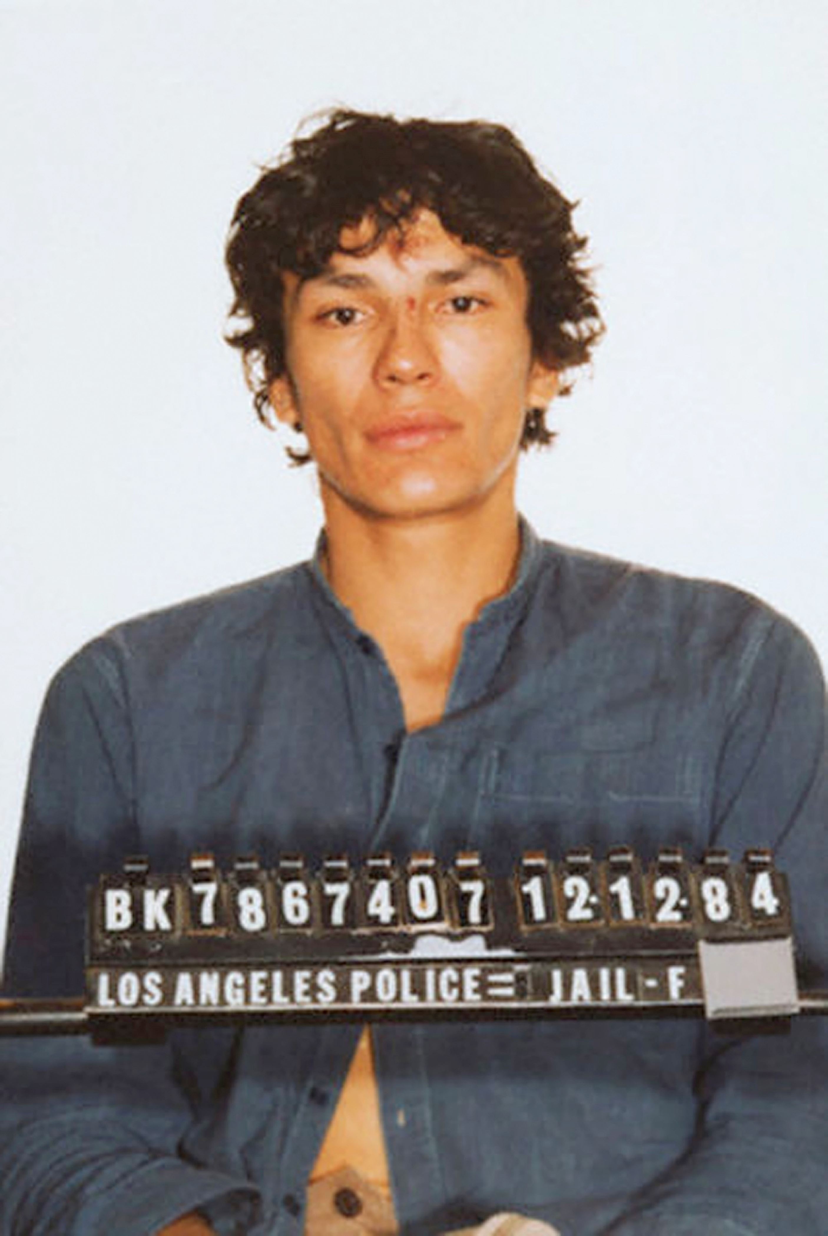 Slide 2 of 14: LOS ANGELES - DECEMBER 12: Serial killer Richard Ramirez aka 'The Night Stalker' in his mug shot or booking photo on DECEMBER 12, 1984 in Los Angeles, California. (Photo by Michael Ochs Archives/Getty Images)