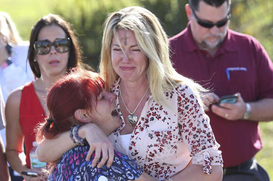 Slide 1 of 11: Parents wait for news after a reports of a shooting at Marjory Stoneman Douglas High School in Parkland, Fla., on Wednesday, Feb. 14, 2018.