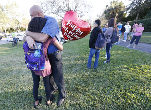 Diapositiva 13 de 29: Family member embrace following a shooting at Marjory Stoneman Douglas High School, Wednesday, Feb. 14, 2018, in Parkland, Fla.