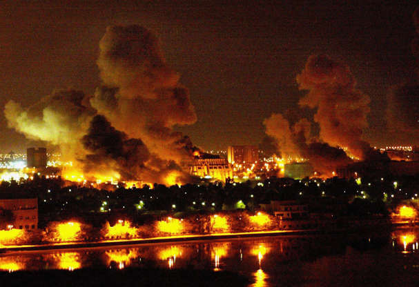 Slide 3 of 50: BAGHDAD, IRAQ - MARCH 21: (USA and Canada SALES ONLY) Fires burn in and around Saddam Hussein's Council of Ministers during the first wave of attacks in the "shock and awe" phase of "Operation Iraqi Freedom" on March 21, 2003 in Baghdad, Iraq. (Photo by Mirrorpix/Getty Images) GETTY IMAGES HAS EXCLUSIVE RIGHTS TO THIS IMAGE IN NORTH AMERICA