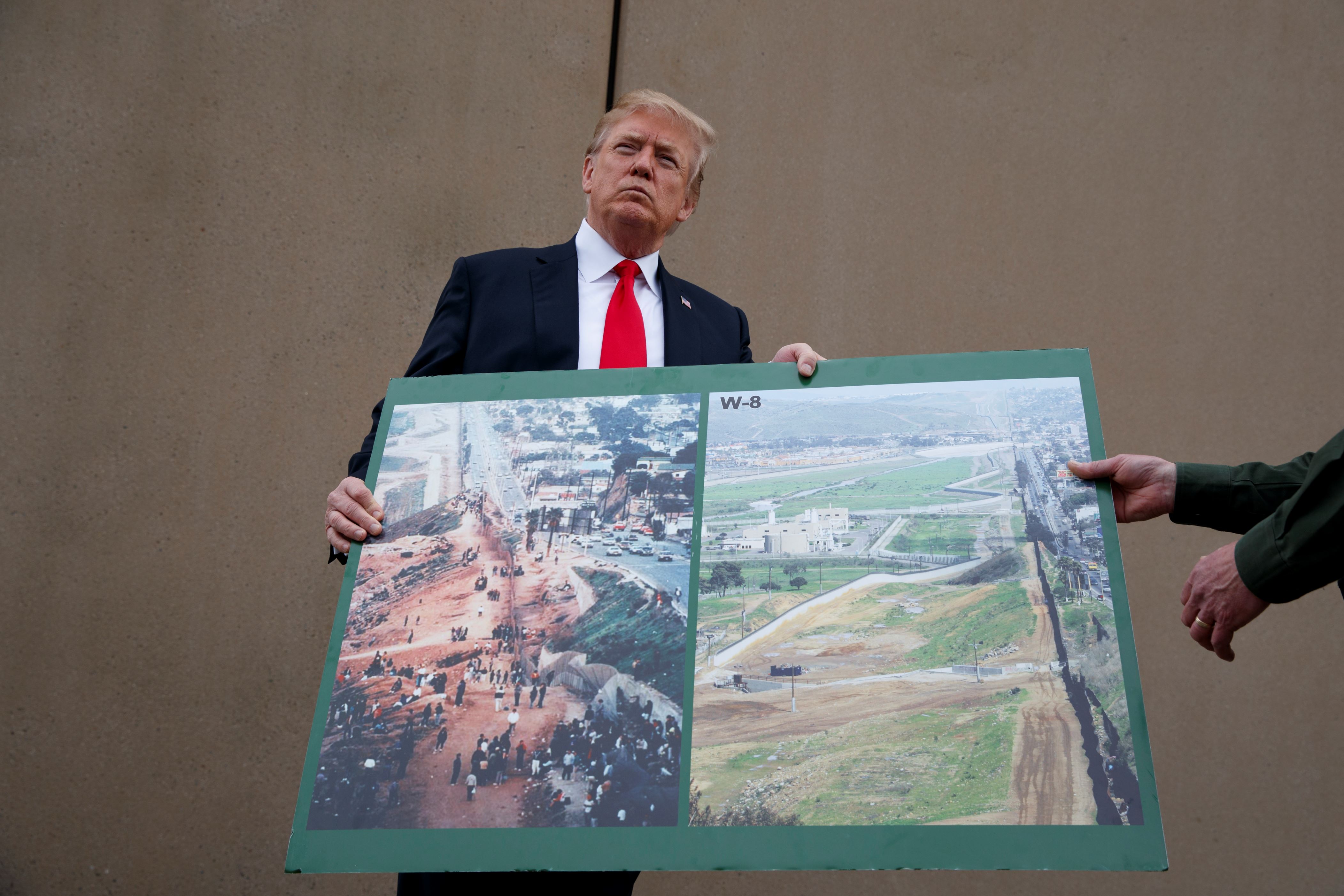 President Donald Trump talks with reporters as he gets a briefing on border wall prototypes, Tuesday, March 13, 2018, in San Diego. (AP Photo/Evan Vucci)
